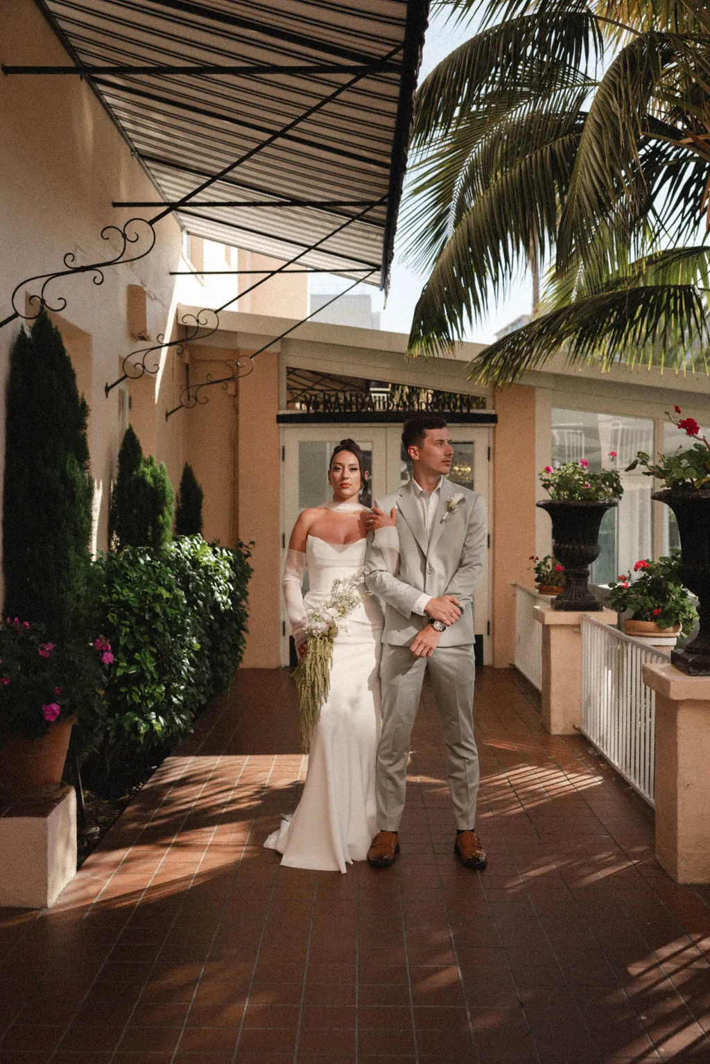 Amber and Tom stand together before their La Jolla wedding ceremony at La Valencia.
