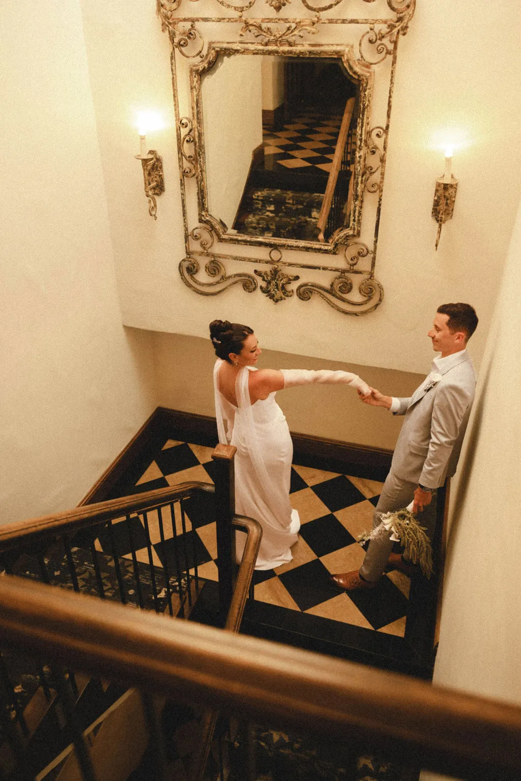 Amber and Tom share a quiet moment on the staircase at La Valencia before their oceanfront ceremony.
